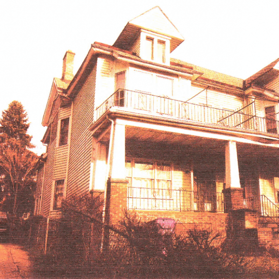 A large house with stairs going up the side of it.