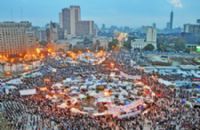 A large crowd of people gathered in the middle of a city.