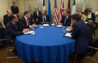 A group of people sitting around a table.