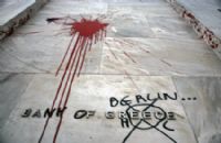 A street with graffiti and blood on the ground.