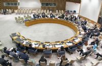 A large round table with people sitting around it.