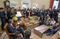 A group of people gathered in the oval office.