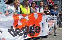 A group of people holding up a banner.