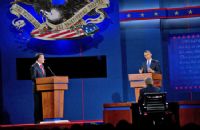 A man and woman are standing at two podiums.