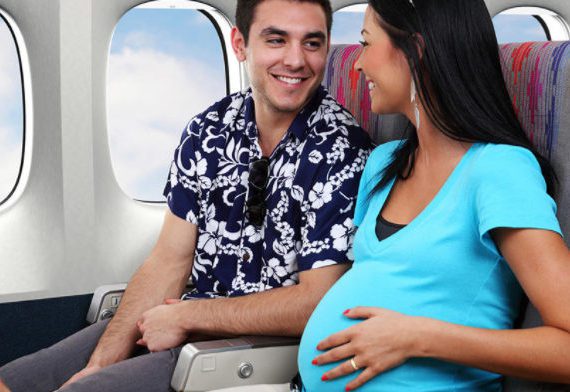 A man and woman sitting on an airplane.